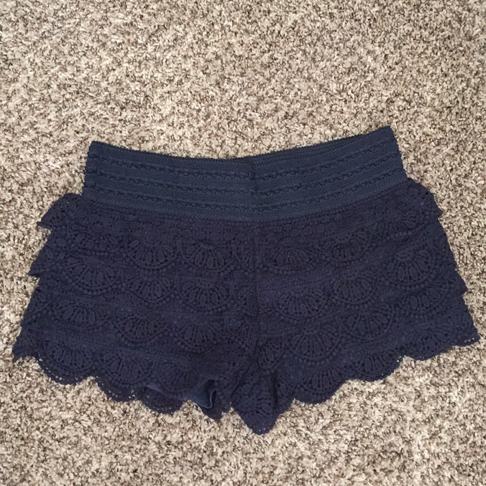Navy blue yarn laced shorts with ruffles.